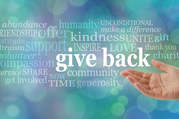 female open hand gesturing towards the words GIVE BACK surrounded by a relevant word cloud against a blue bokeh background