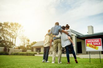 Shot of a family of four viewing their new home together