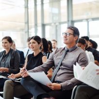 Shot of a group of businesspeople attending a conference