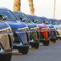 Sitges, Spain - 26th February, 2019: Lexus UX (Toyota Group) SUV vehicles in hybrid version parked on the public parking before the drives. The UX model is the smallest crossover in the Lexus offer. Focus is on the first car on the left.