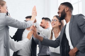 Team achievement, diverse business people giving high five at meeting