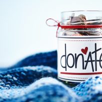 Donation money jar filled with coins