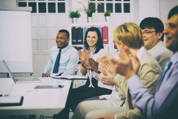 Business people clapping hands