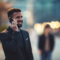 Side view of a young businessman talking on the cellphone.