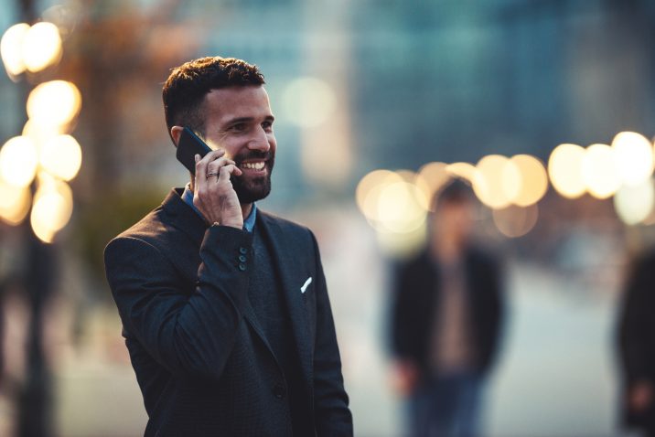 Side view of a young businessman talking on the cellphone.