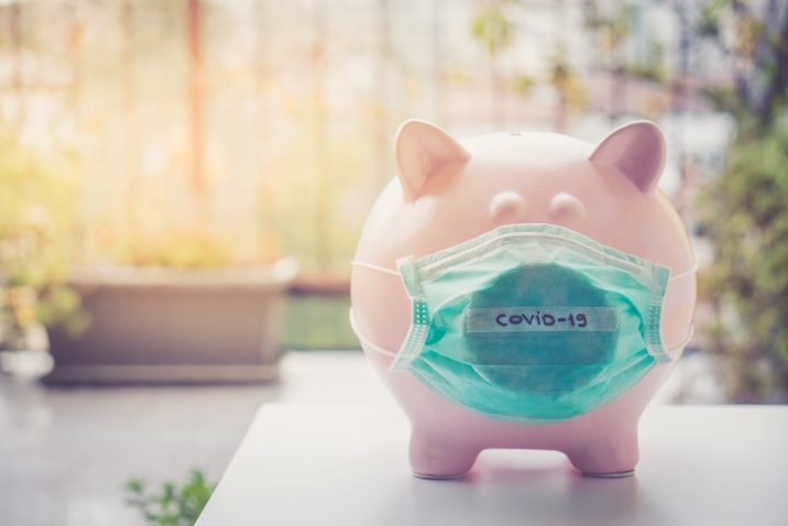 Piggy bank with Face Mask, Financial crisis and market crash due to virus spread.