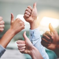 Cropped shot of a group of unrecognizable businesspeople showing thumbs up in an office