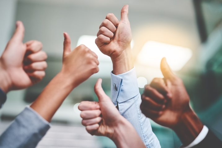 Cropped shot of a group of unrecognizable businesspeople showing thumbs up in an office