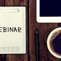 Webinar. Reminder in the calendar. Coffee with calendar and pencil on a wooden countertop. Reminder about training.