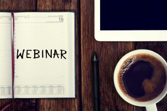 Webinar. Reminder in the calendar. Coffee with calendar and pencil on a wooden countertop. Reminder about training.