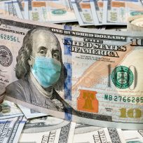 100 dollar money bills with medical face mask, COVID-19 coronavirus in USA.