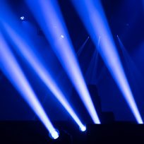 Scene, stage lights with colored spotlights and smoke, laser lights background, white and blue