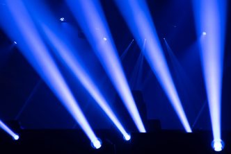 Scene, stage lights with colored spotlights and smoke, laser lights background, white and blue